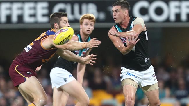 Tom Rockliff of the Power handballs during the round three AFL match against Brisbane at The Gabba. Picture: Chris Hyde/Getty Images