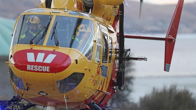 Missing Victorian bushwalker, Michael Bowman arrives via the Westpac Rescue helicopter with Tasmania Police at the Hobart Cenotaph. Picture: LUKE BOWDEN