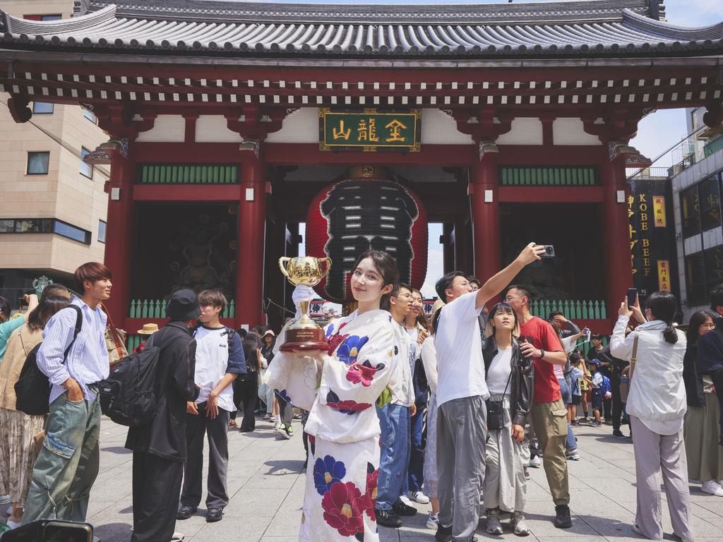 Japanese model Marina with the Lexus Melbourne Cup trophy at the Asakusa Shrine in Tokyo – the first stop on the tour. Picture: Shungotanaka