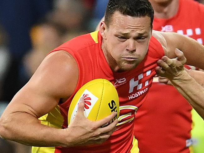 Steven May of the Suns (left) and Tom McDonald of the Demons compete for the ball during the Round 8 AFL match between the Gold Coast Suns and the Melbourne Demons at the Gabba in Brisbane, Saturday, May 12, 2018. (AAP Image/Dan Peled) NO ARCHIVING, EDITORIAL USE ONLY