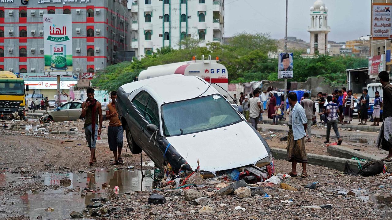 People assess the damage in Mukalla in Yemen's coastal southern Hadramawt province, on October 7, 2021. Picture: AFP