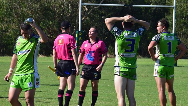 NRRRL referee Josh Gollan consults one of his sideline officials in a game last year. The refs have agreed to a pay cut to help get the season started in July.