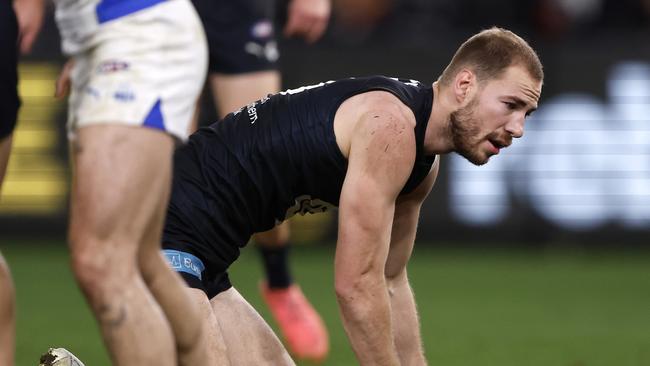 MELBOURNE, AUSTRALIA - JULY 21:  Harry McKay of the Blues is helped to his feet after a heavy collision during the round 19 AFL match between Carlton Blues and North Melbourne Kangaroos at Marvel Stadium, on July 21, 2024, in Melbourne, Australia. (Photo by Darrian Traynor/Getty Images)