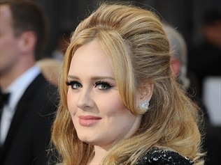 Singer Adele has won a five-figure settlement after photos were taken of her two-year-old son.