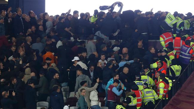 Stewards try to separate supporters of both sides.