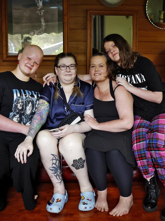 Kay has her final cuddles with great-niece Hanne (left), niece Necole and great-niece Kendra (right). Picture: Sam Ruttyn