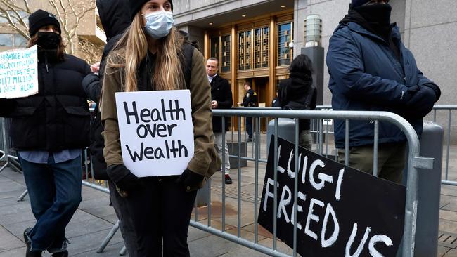 People demonstrating against the healthcare industry stand outside Federal Criminal Court as Luigi Mangione appears during an arraignment hearing. Picture: John Lamparski/Getty Images/AFP