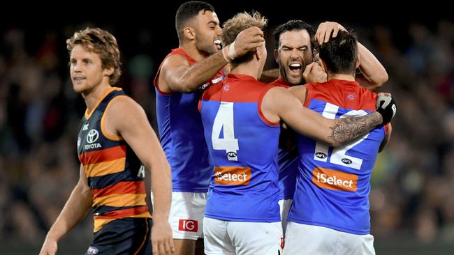 Melbourne players celebrate a Jordan Lewis goal.