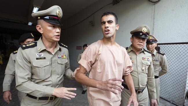 Bahraini Hakeem al-Araibi, center, leaves the criminal court in Bangkok, Thailand, Bangkok, Thailand, Monday, Feb. 4, 2019. The soccer player who has refugee status in Australia told a Thai court Monday that he refuses to be voluntarily extradited to Bahrain, which has asked for his return to serve a prison sentence for a crime he denies committing. (AP Photo Wason Wanichakorn)