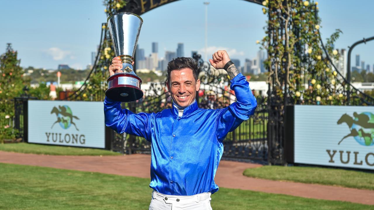 Dean Holland holds the Newmarket Handicap trophy after winning the race with In Secret earlier this year. Picture: Reg Ryan