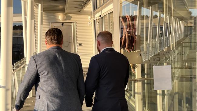 Michael Burke (right) leaves the Defence Force Magistrates Court with a supporter on August 31 2022. Picture: Julia Kanapathippillai