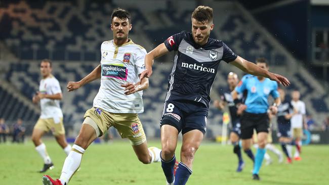 Terry Antonis and Johnny Koutroumbis compete for the ball.