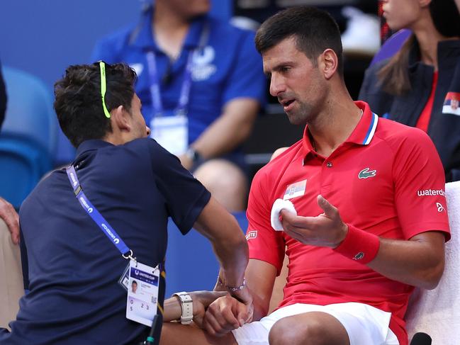 PERTH, AUSTRALIA - JANUARY 03: Novak Djokovic of Team Serbia receives treatment to his right arm during his singles match against Alex de Minaur of Team Australia during day six of the 2024 United Cup at RAC Arena on January 03, 2024 in Perth, Australia. (Photo by Paul Kane/Getty Images)