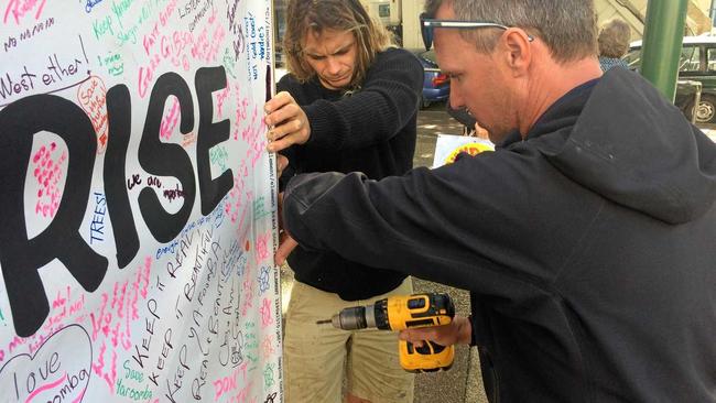 Point Arkwright resident Clancy McGowan, left and Yaroomba resident Jason Ward erect a banner in front of Sunshine Coast Council's Nambour chambers detailing community opposition to Sekisui House's Yaroomba Beach development proposal. Picture: Stuart Cumming