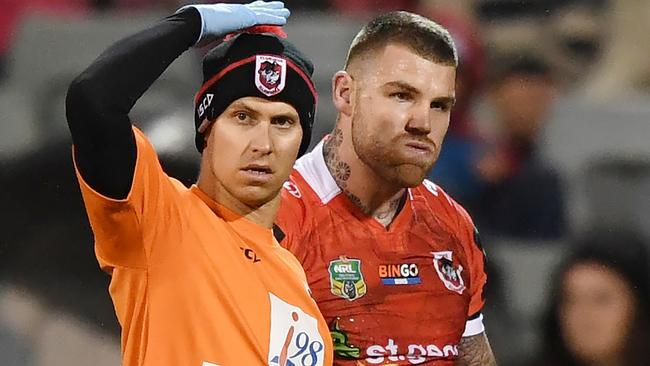 Josh Dugan is helped off the field for a head injury assessment.