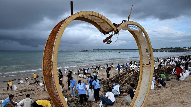 Participants and volunteers remove plastic waste and other garbage washed ashore at a beach in Kedonganan Badung regency, Indonesia's Bali island. Picture: AFP