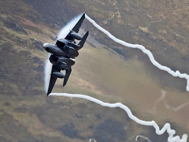 DOLGELLAU, WALES - FEBRUARY 16:  A United States Air Force F-15 fighter jet based at RAF Lakenheath speeds through the Dinas Pass, known in the aviation world as the Mach Loop on February 16, 2018 in Dolgellau, Wales. United Kingdom. The Royal Air Force and aircraft of the United States use the valleys of Snowdonia to practice low flying techniques and pilot training. The mountain peak vantage points attract aviation enthusiasts from all over the world who hope for a glimpse of their favourite military aircraft spending days waiting for the un-published and un-scheduled fly pasts.  (Photo by Christopher Furlong/Getty Images)
