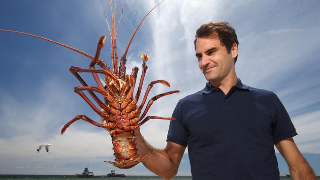 Federer holds a Western Rock Lobster. Picture: Getty Images