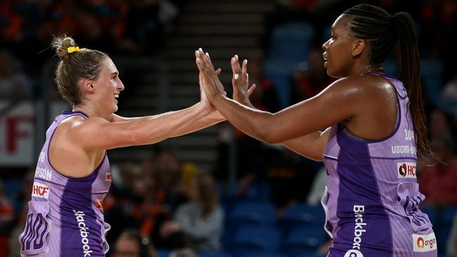 Gabi Simpson (left) and Eboni Usoro-Brown of the Firebirds celebrate during the round four Super Netball match against the Giants. Photo: Getty Images