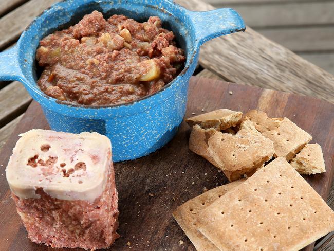 23/4/15 - Tony Love taste tests the core Anzac food rations including Hard Tack biscuit (aka Anzac Tiles), bully (corned) beef from the tin, and also bully beef stew. Picture Simon Cross