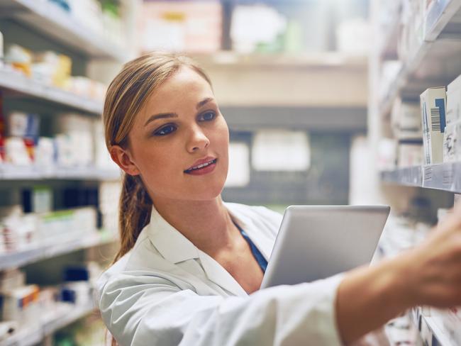 Shot of a pharmacist using her digital tablet while working in a isle