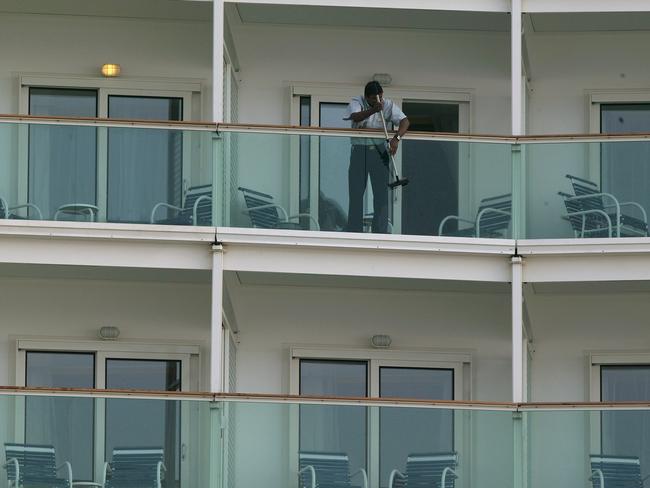 SOUTHAMPTON, UNITED KINGDOM - APRIL 22:  Passengers look out from balconies on world's largest ocean liner, the 'Liberty of the Seas' as it arrives at the Port of Southampton, on April 22, 2007 in Southampton, England. The enormous cruiser, owned by Royal Caribbean is over 1000ft in length and has capacity for 4,300 passengers spread over 15 decks. (Photo by Bruno Vincent/Getty Images)