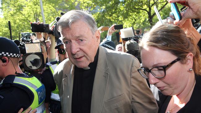 TOPSHOT - Cardinal George Pell (C) makes his way to the court in Melbourne on February 27, 2019. - Cardinal George Pell arrived in court, possibly for the last time as a free man, in a last-ditch push to apply for bail after his historic conviction for child sex crimes. (Photo by Con CHRONIS / AFP)