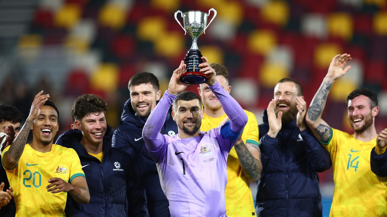 Mathew Ryan of Australia celebrates and lifts the Trans-Tasman Trophy. Photo by Bryn Lennon/Getty Images.