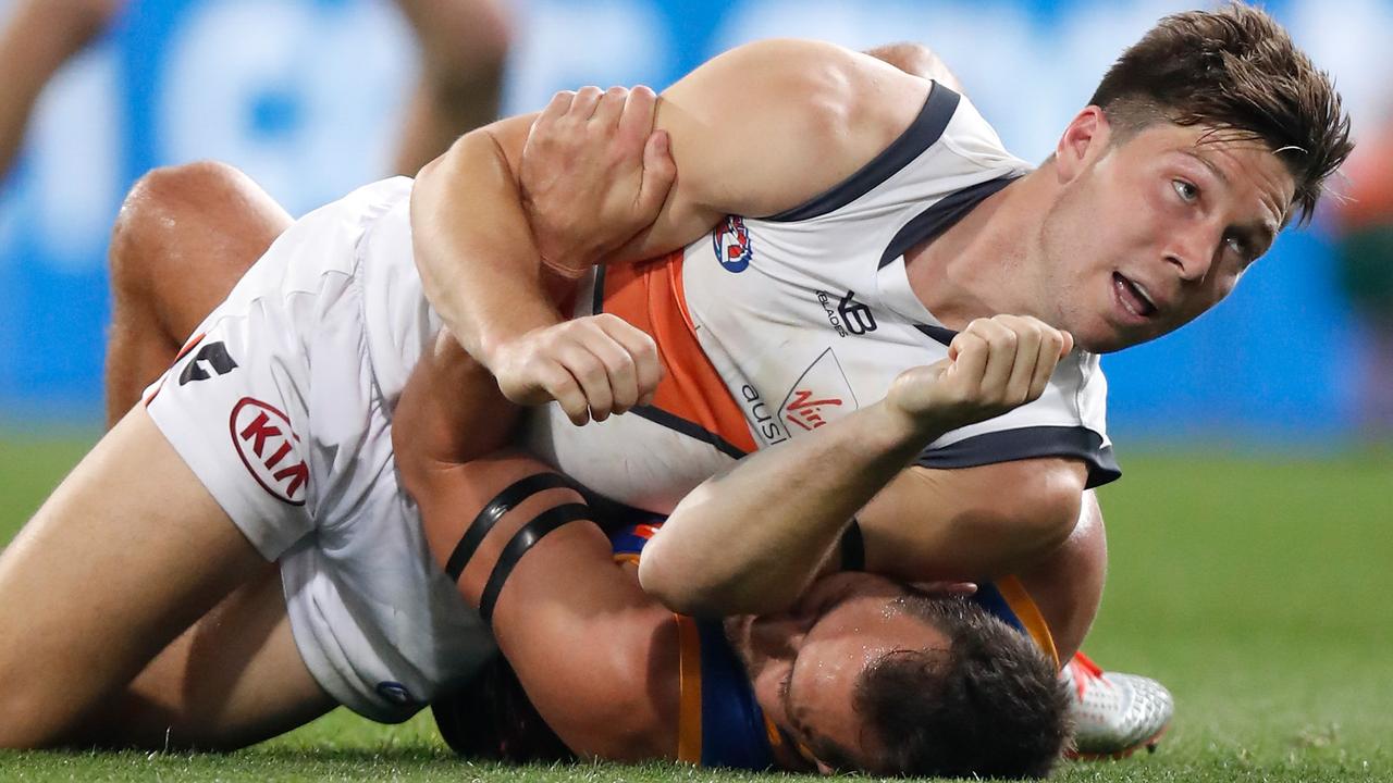 Toby Greene grapples with Luke Hodge in Saturday’s clash at the Gabba.