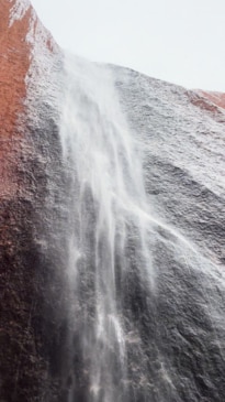 Rare rain on Uluru creates stunning waterfall