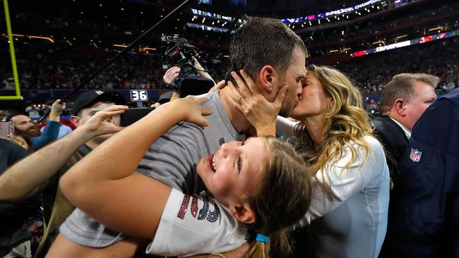 Tom Brady of the New England Patriots kisses his wife. Photo by Kevin C. Cox/Getty Images