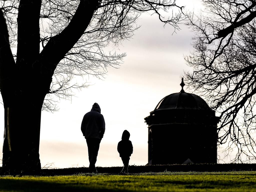 A father and son exercise in Melbourne's Flagstaff Gardens during stage 4 lockdown as the state of Victoria continues to battle a second wave of COVID-19 infections. Picture: Ian Currie