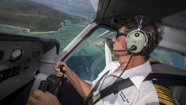 ‘The new corals are that bright you need sunglasses on’: Daintree Air chief pilot Greg Letondeur checks out Lizard Island’s Blue Lagoon. Picture: Brian Cassey