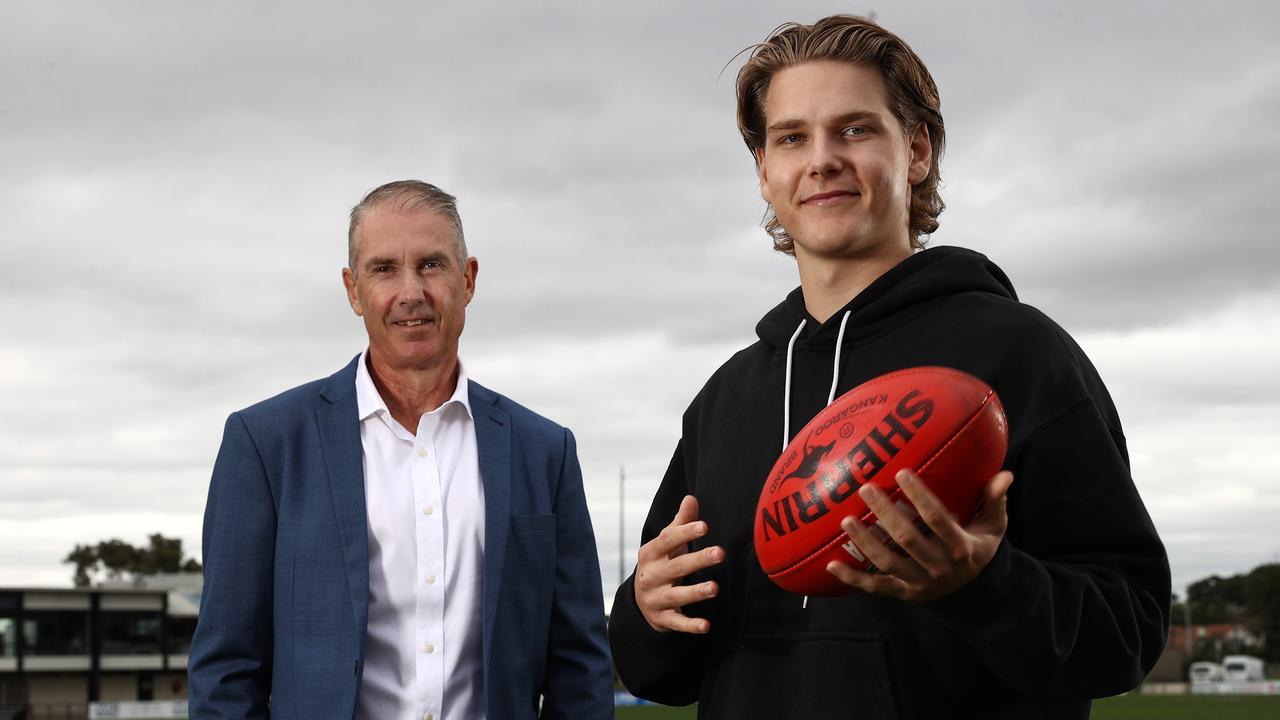 Lions player Will Ashcroft, with his father Marcus, a three-time Brisbane premiership player, at Trevor Barker Oval. Picture: Michael Klein