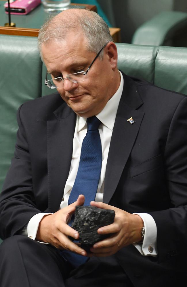 Scott Morrison looks at a piece of coal during House of Representatives Question Time at Parliament House in Canberra. Picture: AAP