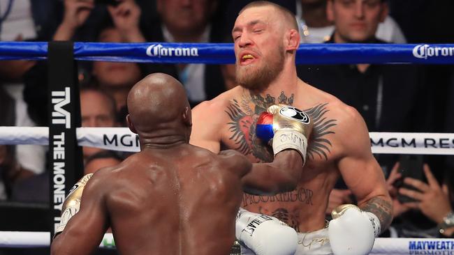 Floyd Mayweather Jr. throws a punch at Conor McGregor.