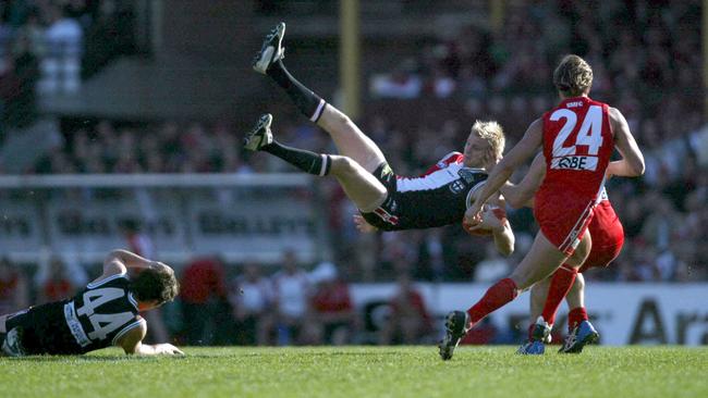 Nick Riewoldt crashes over teammate Stephen Milne to take a spectacular mark.