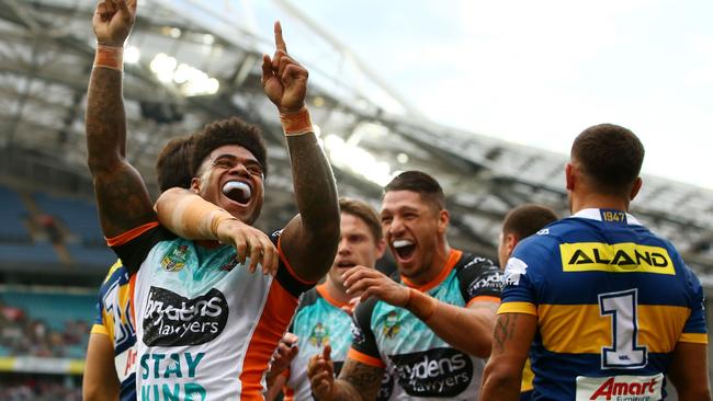 Kevin Naiqama of the Tigers celebrates scoring as try against the Eels.