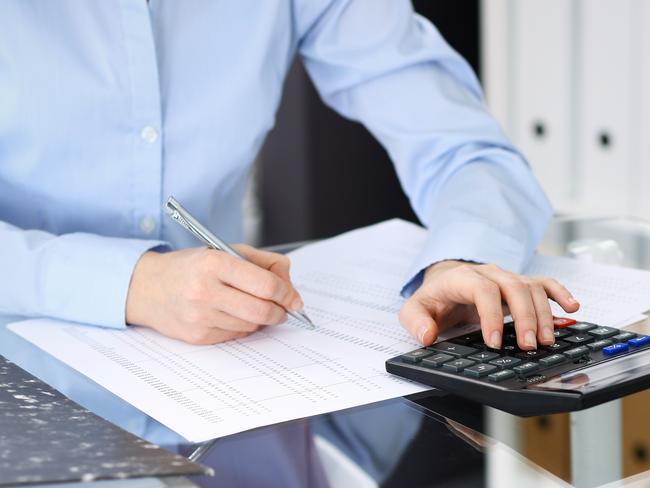 Unknown bookkeeper woman or financial inspector making report, calculating or checking balance, close-up. Business portrait. Audit or tax concepts.