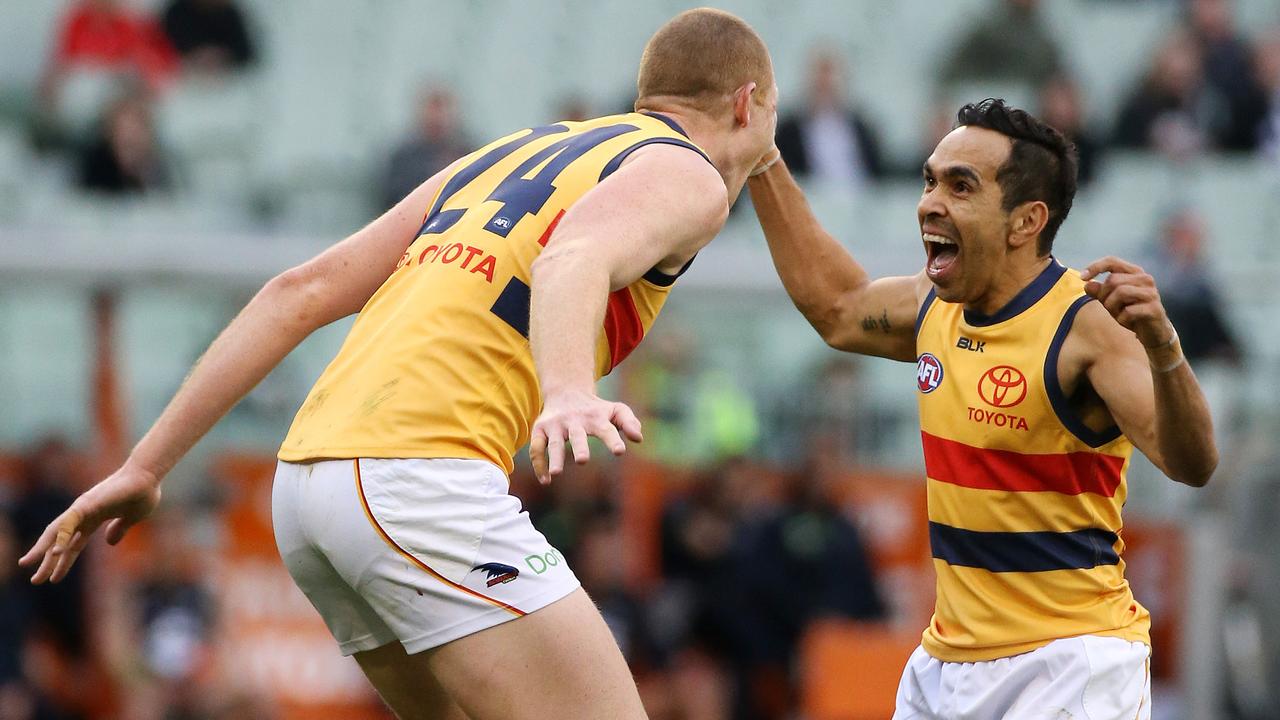Former Blues Sam Jacobs and Eddie Betts celebrate a goal for Adelaide.