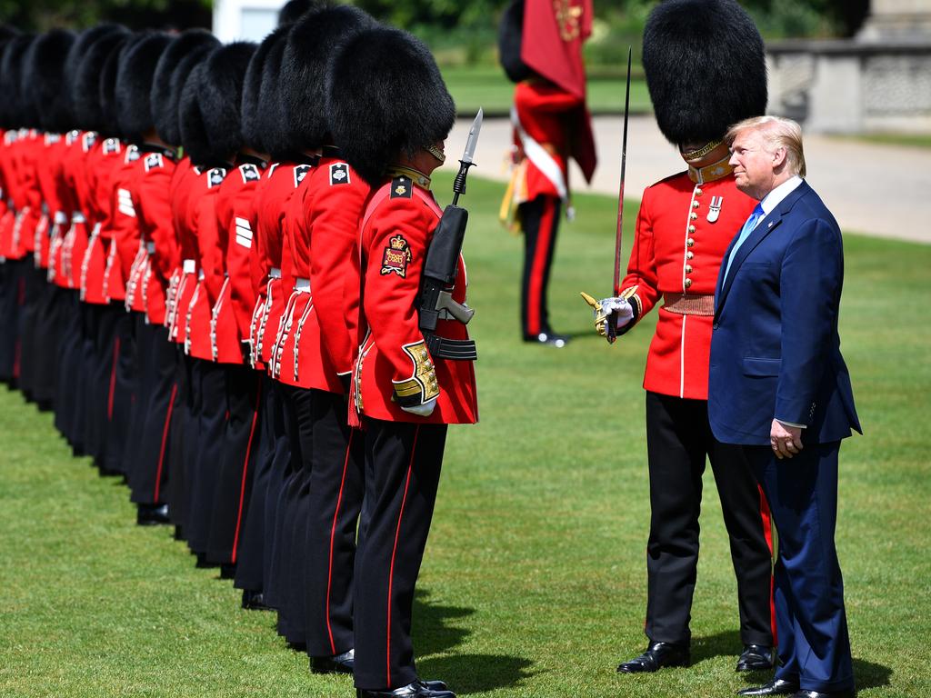 President Donald Trump stops for a long chat with a member of the guard of honour. Picture: Jeff J Mitchell/Getty Images.