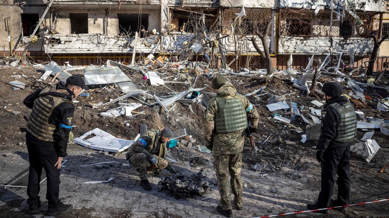 Ukrainian soldiers inspect the rubble of a destroyed apartment building in Kyiv. Picture: Fadel Senna / AFP