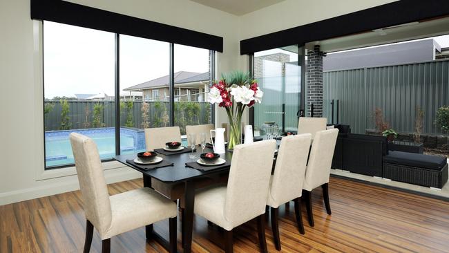 The dining area flows on to an outdoor patio that adjoins the swimming pool.