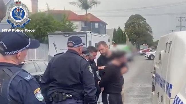 A man is arrested by heavily-armed police on Everton St, Hamilton on Tuesday following an investigation into a series of armed robberies across the Hunter. Picture: NSW Police.