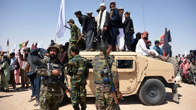 Taliban militants and Afghan National Army troops celebrate in Kandahar province during the last ceasefire in 2018. Picture: AFP