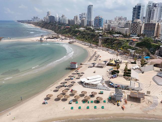 TOPSHOT - An aerial view shows empty beaches in the Israeli coastal city of Netanya, on April 14, 2024. Iran launched its first-ever direct attack on Israeli territory late on April 13, marking a major escalation of the long-running covert war between the regional foes and sparking fears of a broader conflict breaking out. (Photo by JACK GUEZ / AFP)