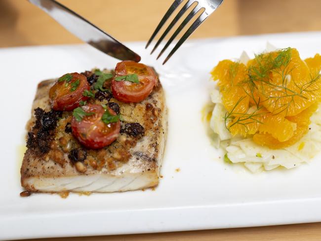 Humpty Doo Barramundi prepared by Bella Darwin Restaurant chefs. The oven-baked fish is served with breadcrumb, pine nuts, raisins, cherry tomatoes and fennel and orange salad. Picture: Floss Adams.