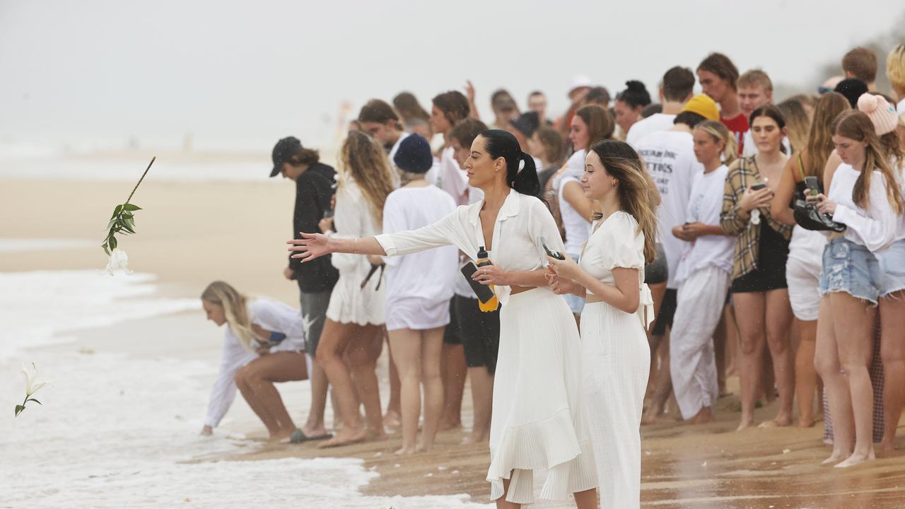 Family and friends of 16-year-old alleged stabbing victim Balin Stewart gather to pay tribute on his home beach at Buddina. Picture: Lachie Millard