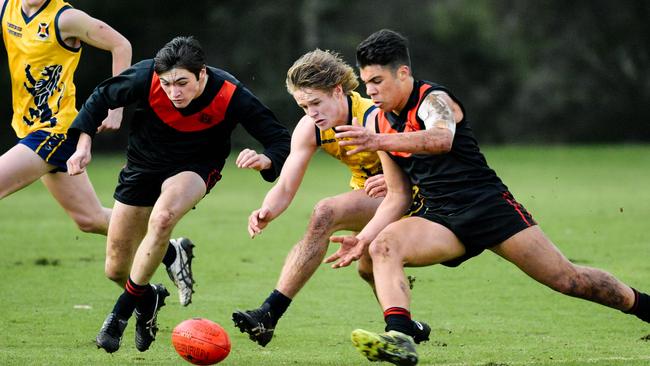 Cameron Taheny, left, prepares to pounce on the ball in a match for Rostrevor against Scotch College. Picture: AAP Image/Morgan Sette