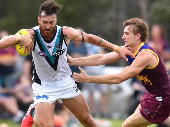 Charlie Dixon (left) of the Power is tackled by Harris Andrews (right) of the Lions during the AFL Marsh Community Series pre-season match between the Brisbane Lions and the Port Adelaide Power at the Moreton Bay Central Sports Complex in Burpengary, Queensland, Sunday, February 23, 2020. (AAP Image/Darren England) NO ARCHIVING, EDITORIAL USE ONLY